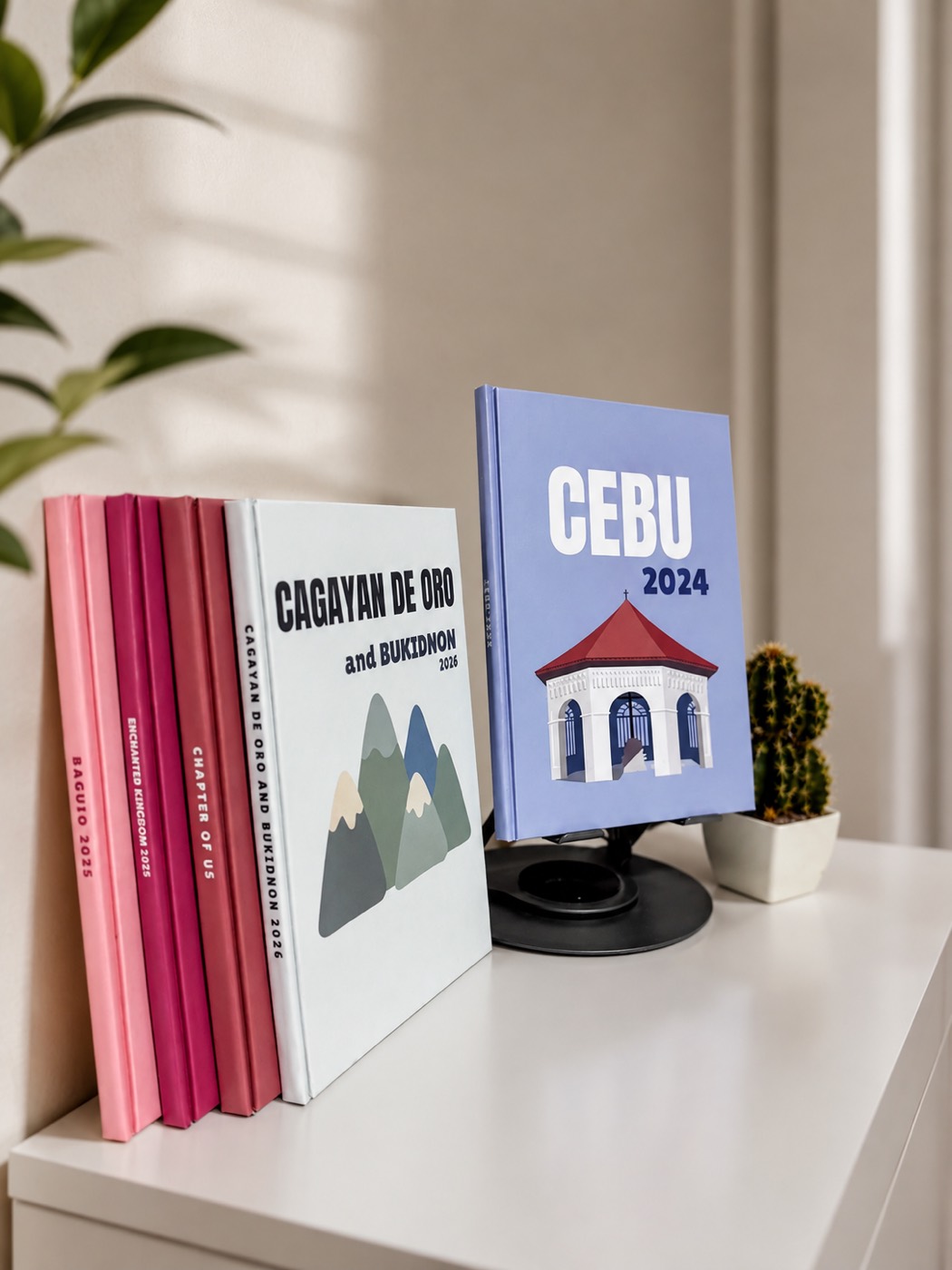Paper Collective photobooks lined up on a shelf beside the Cebu 2024 edition